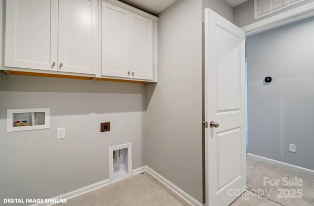 washroom featuring hookup for an electric dryer, cabinet space, hookup for a washing machine, and baseboards