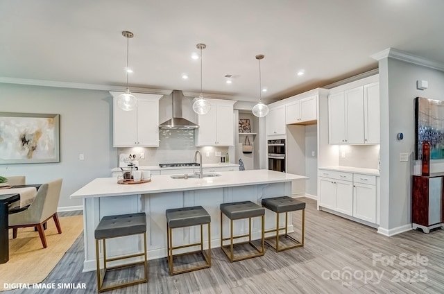 9945 Cask Way, Huntersville, NC 28078 - kitchen with wall chimney range hood, a sink, white cabinetry, light countertops, and light wood-type flooring