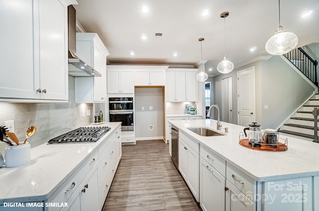 9945 Cask Way, Huntersville, NC 28078 - kitchen featuring a sink, stainless steel appliances, an island with sink, wood finished floors, and white cabinetry