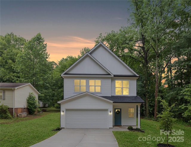 515 Dixie Dr, Mooresville, NC 28115 - view of front of house with concrete driveway, a garage, a lawn, board and batten siding, and a shingled roof