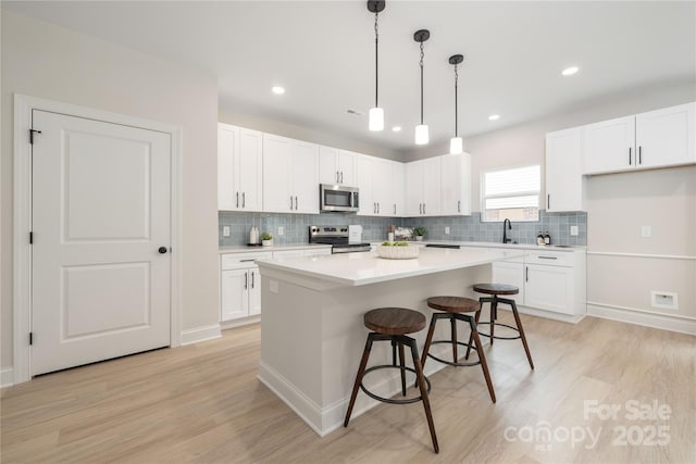 515 Dixie Dr, Mooresville, NC 28115 - kitchen featuring stainless steel appliances, light wood-style floors, backsplash, and recessed lighting