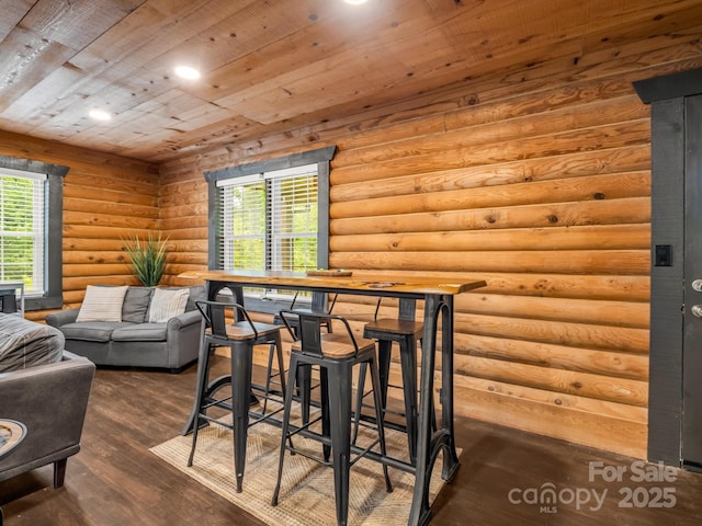 dining room with wood finished floors, wood ceiling, log walls, and recessed lighting