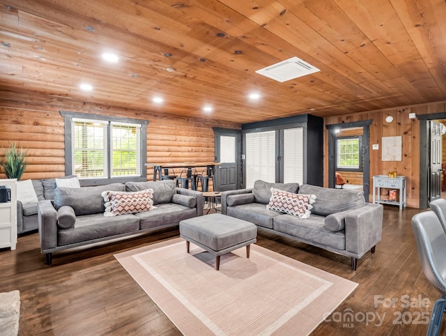 living room with log walls, wooden ceiling, dark wood-style flooring, and recessed lighting