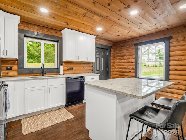 kitchen featuring dishwasher, a sink, log walls, a kitchen island, and dark wood-style flooring