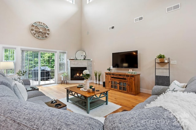 4616 Gold Finch Dr, Denver, NC 28037 - living area featuring wood finished floors, a high ceiling, a premium fireplace, and baseboards
