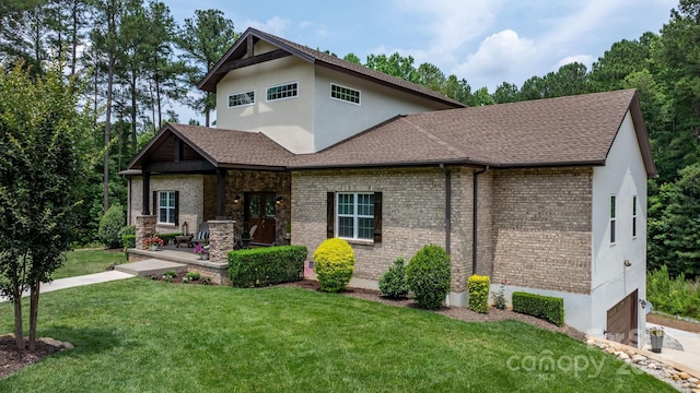 4616 Gold Finch Dr, Denver, NC 28037 - craftsman house featuring a front yard, an attached garage, brick siding, and roof with shingles