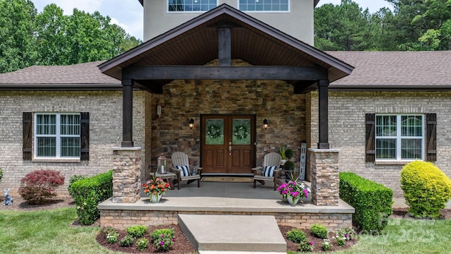 4616 Gold Finch Dr, Denver, NC 28037 - property entrance with french doors, brick siding, roof with shingles, and covered porch