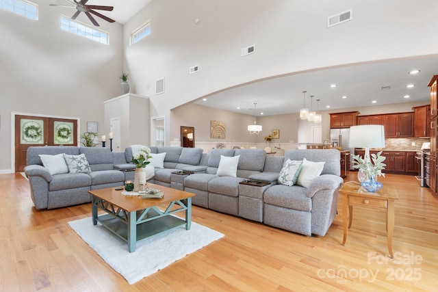 4616 Gold Finch Dr, Denver, NC 28037 - living room with ceiling fan, a towering ceiling, light wood finished floors, arched walkways, and recessed lighting