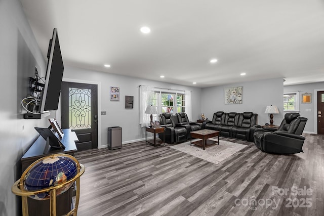 living room with wood finished floors, recessed lighting, and baseboards