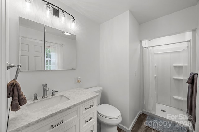 full bath with wood finished floors, a shower stall, toilet, and vanity