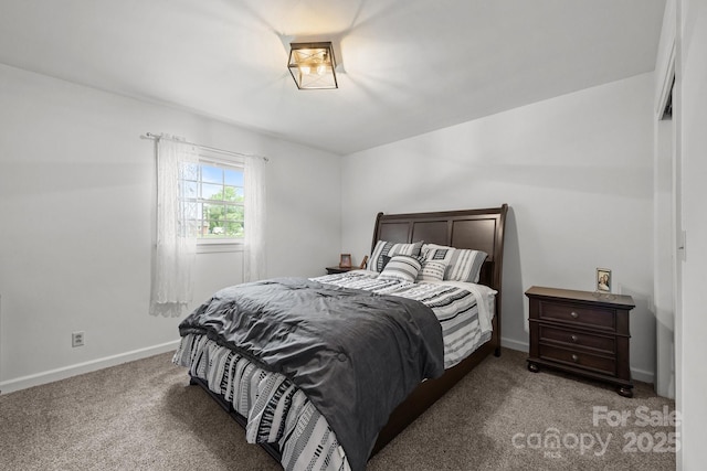 bedroom featuring light colored carpet and baseboards