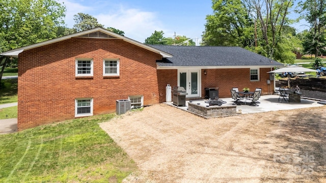 rear view of house with brick siding, a patio, french doors, and central air condition unit