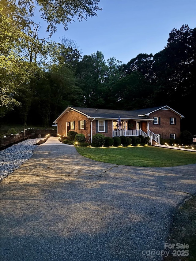 2076 Junction Rd, Mocksville, NC 27028 - single story home featuring driveway, a front yard, covered porch, and brick siding