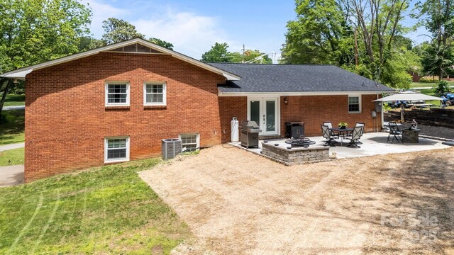 2076 Junction Rd, Mocksville, NC 27028 - back of property with brick siding, french doors, a patio, and central AC unit