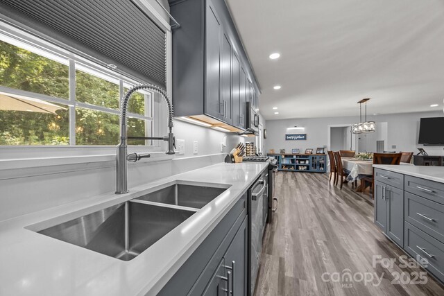 2076 Junction Rd, Mocksville, NC 27028 - kitchen with a sink, gray cabinetry, recessed lighting, decorative light fixtures, and wood finished floors