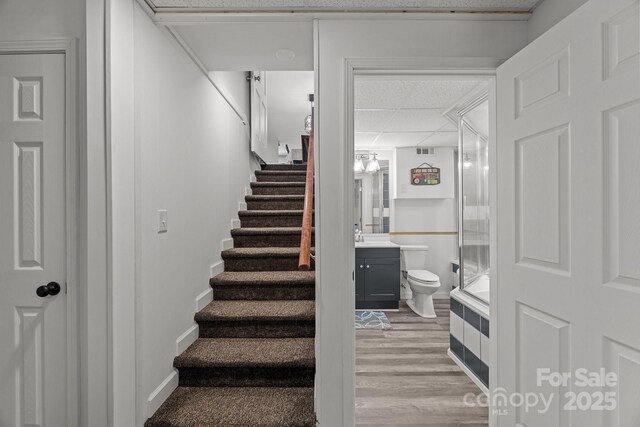 2076 Junction Rd, Mocksville, NC 27028 - stairway featuring a paneled ceiling and wood finished floors