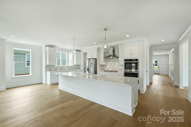13605 Tranquil Day Dr, Matthews, NC 28105 - kitchen featuring wall chimney exhaust hood, stainless steel appliances, tasteful backsplash, light countertops, and white cabinetry