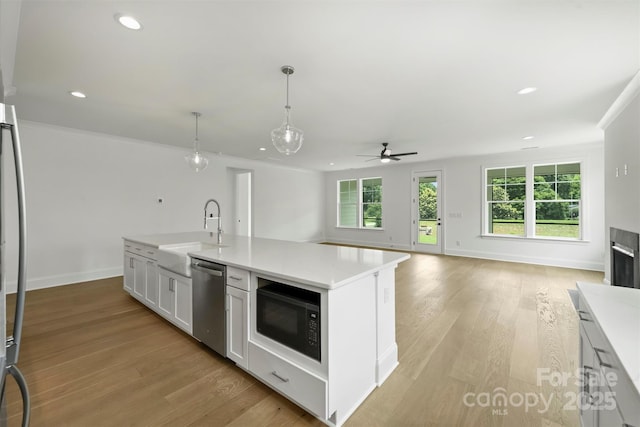 13605 Tranquil Day Dr, Matthews, NC 28105 - kitchen with stainless steel dishwasher, black microwave, a ceiling fan, recessed lighting, and light countertops