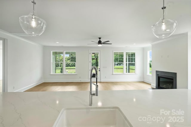 13605 Tranquil Day Dr, Matthews, NC 28105 - kitchen with open floor plan, healthy amount of natural light, a glass covered fireplace, wood finished floors, and recessed lighting