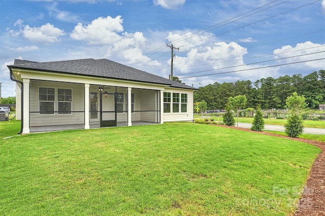13605 Tranquil Day Dr, Matthews, NC 28105 - back of house featuring a yard, a shingled roof, and a sunroom