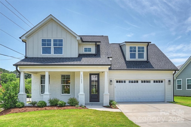 13605 Tranquil Day Dr, Matthews, NC 28105 - view of front of property with covered porch, a front lawn, concrete driveway, and board and batten siding