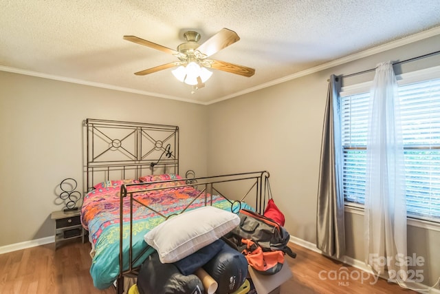 4424 Huntington Dr, Gastonia, NC 28056 - bedroom with wood finished floors, multiple windows, a textured ceiling, ornamental molding, and baseboards