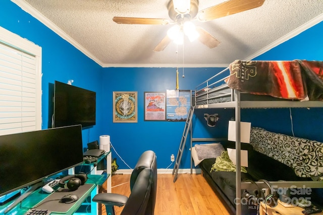 4424 Huntington Dr, Gastonia, NC 28056 - bedroom featuring a textured ceiling, crown molding, wood finished floors, a ceiling fan, and an office area