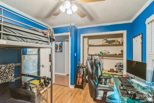 4424 Huntington Dr, Gastonia, NC 28056 - bedroom with a textured ceiling, wood finished floors, crown molding, a closet, and a ceiling fan