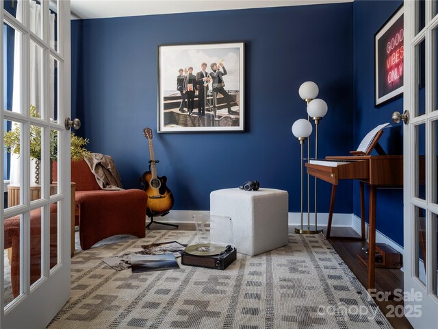 living area with french doors and baseboards