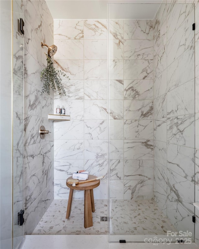 full bath with a marble finish shower