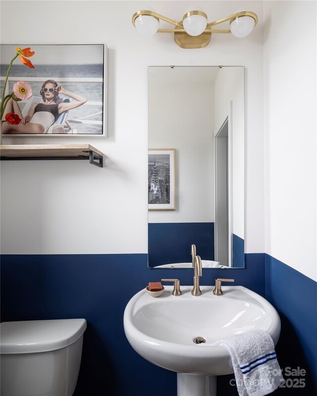 bathroom with toilet and a sink
