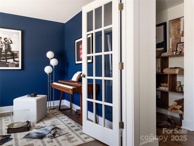 interior space featuring wood finished floors and baseboards