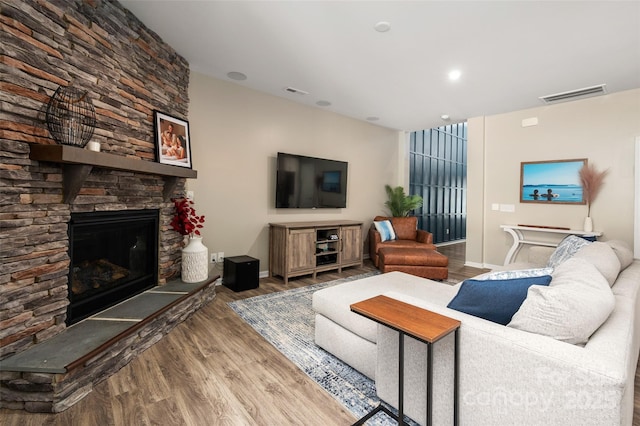 5014 Forest Hills Pl, Fort Mill, SC 29707 - living area featuring wood finished floors, a stone fireplace, and baseboards