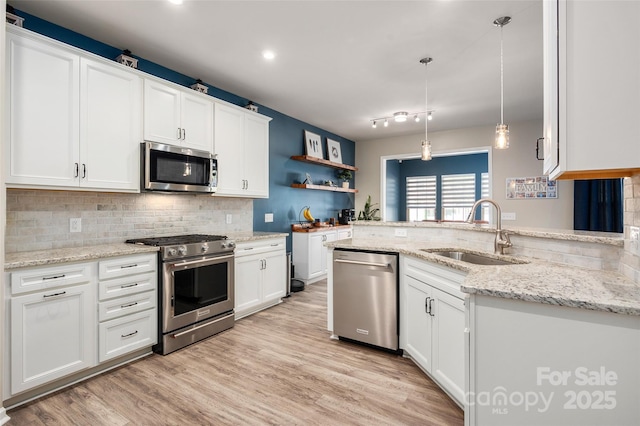 5014 Forest Hills Pl, Fort Mill, SC 29707 - kitchen featuring stainless steel appliances, a sink, white cabinets, tasteful backsplash, and light wood-style floors