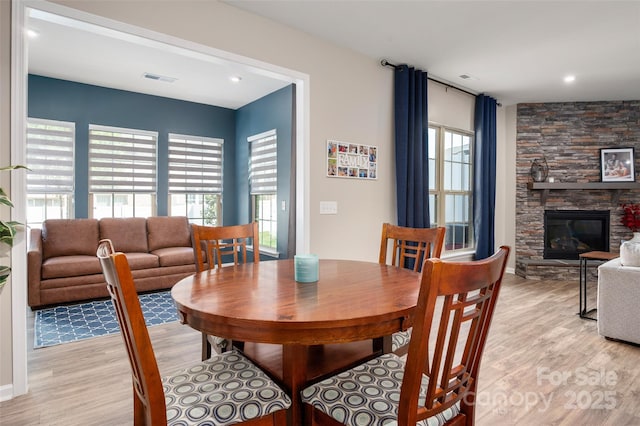 5014 Forest Hills Pl, Fort Mill, SC 29707 - dining room with light wood-style floors, a stone fireplace, baseboards, and recessed lighting
