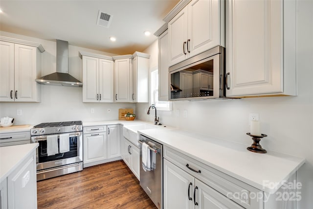 18011 Wilbanks Dr, Charlotte, NC 28278 - kitchen with wall chimney range hood, stainless steel appliances, a sink, recessed lighting, and dark wood-style flooring