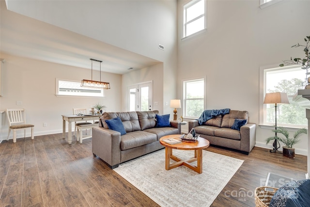 18011 Wilbanks Dr, Charlotte, NC 28278 - living area with dark wood-style flooring, baseboards, a high ceiling, and a chandelier