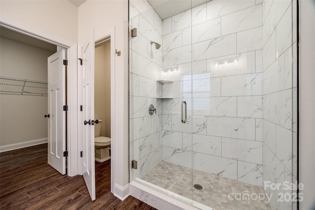 18011 Wilbanks Dr, Charlotte, NC 28278 - bathroom featuring a shower stall, wood finished floors, baseboards, and toilet