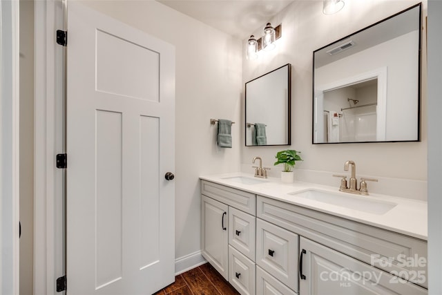 18011 Wilbanks Dr, Charlotte, NC 28278 - bathroom featuring double vanity, wood finished floors, and baseboards