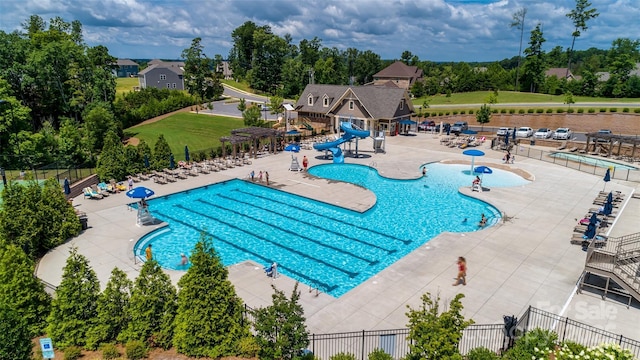 18011 Wilbanks Dr, Charlotte, NC 28278 - community pool featuring a water slide, fence, and a patio area