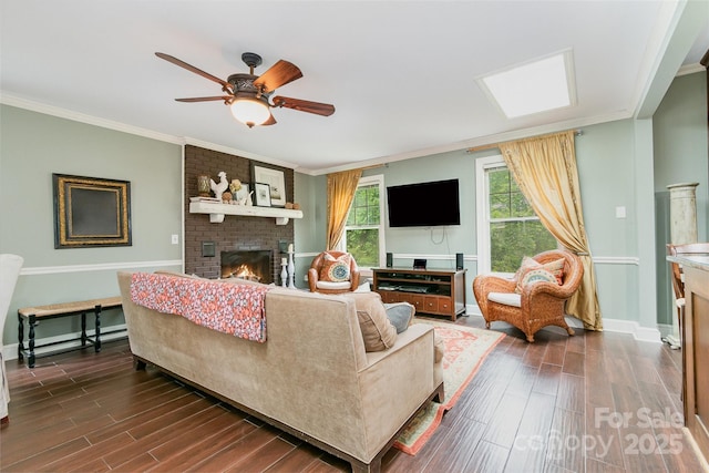 408 Idlewood Dr, Kannapolis, NC 28083 - living room with a brick fireplace, dark wood-style floors, baseboards, ornamental molding, and a ceiling fan