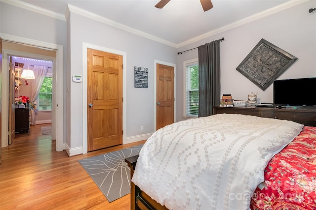 408 Idlewood Dr, Kannapolis, NC 28083 - bedroom with light wood finished floors, multiple windows, crown molding, baseboards, and a ceiling fan