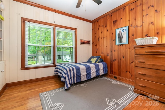 408 Idlewood Dr, Kannapolis, NC 28083 - bedroom featuring wood finished floors, multiple windows, baseboards, wooden walls, and crown molding