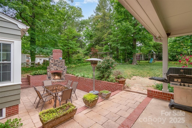 408 Idlewood Dr, Kannapolis, NC 28083 - view of patio with an outdoor stone fireplace, a playground, outdoor dining space, and view of wooded area