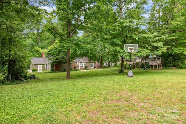 408 Idlewood Dr, Kannapolis, NC 28083 - view of grassy yard featuring a playground and view of wooded area