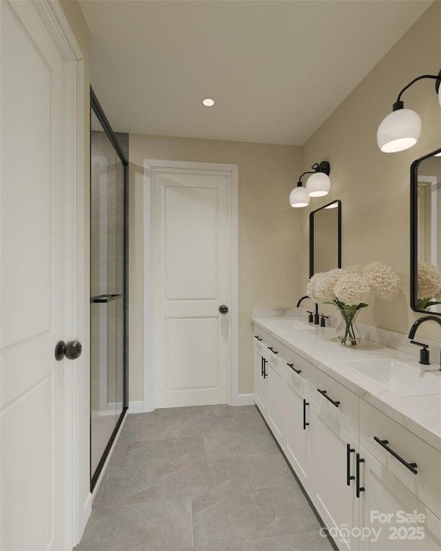 bathroom featuring a shower stall, double vanity, and recessed lighting