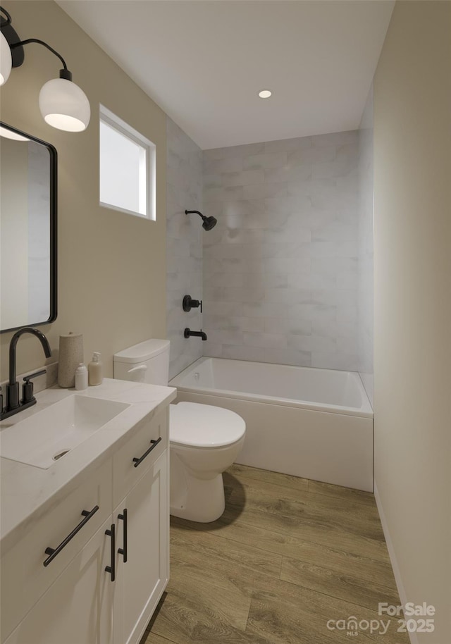 bathroom featuring wood finished floors, toilet,  shower combination, vanity, and recessed lighting