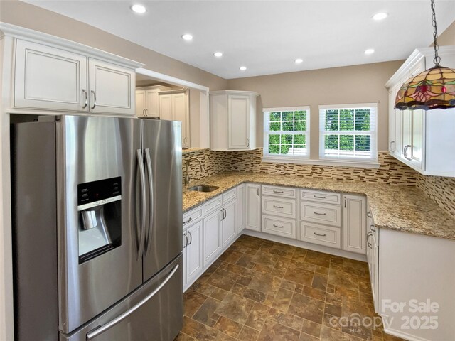 903 Furman Ct, Fort Mill, SC 29708 - kitchen featuring stainless steel refrigerator with ice dispenser, a sink, decorative backsplash, white cabinetry, and recessed lighting
