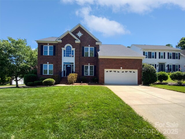 903 Furman Ct, Fort Mill, SC 29708 - colonial inspired home featuring an attached garage, brick siding, a front yard, and concrete driveway