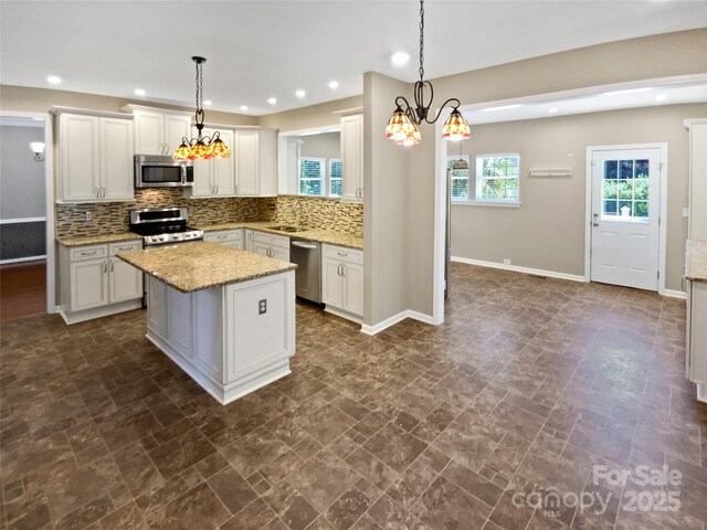 903 Furman Ct, Fort Mill, SC 29708 - kitchen featuring stainless steel appliances, tasteful backsplash, a kitchen island, recessed lighting, and light stone counters